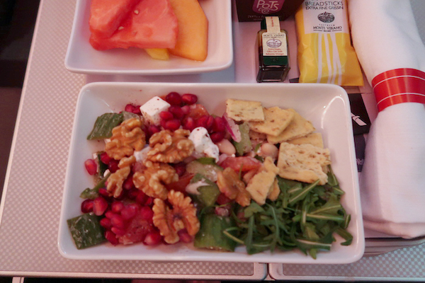 a plate of salad and fruit