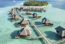 a group of huts on water