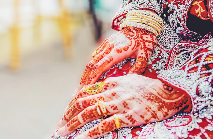 a close up of hands with henna designs
