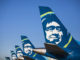 a group of airplanes with faces on the tail