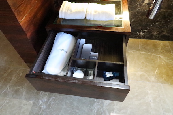 a drawer with a towel and other items inside
