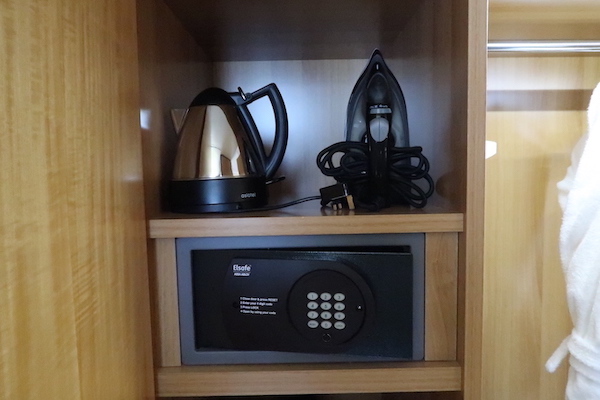 a shelf with a kettle and a iron on it