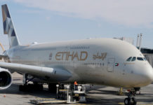 a large white airplane with gold lettering on it