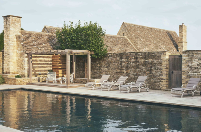 a pool with chairs and a pergola