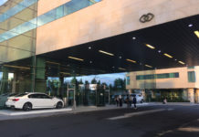 a building with glass walls and cars