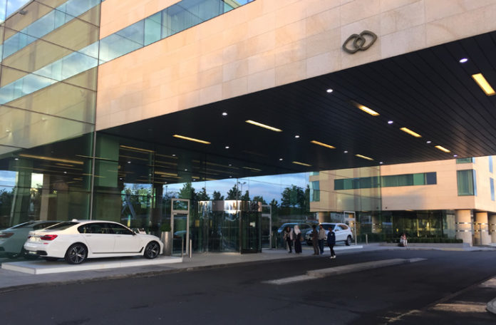 a building with glass walls and cars
