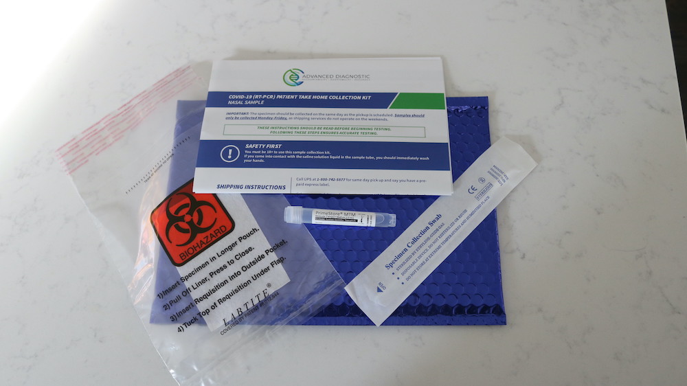 a blue package with a label and a test tube