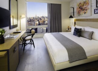a bedroom with a large bed and a desk