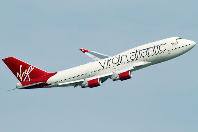 a white and red airplane in the sky