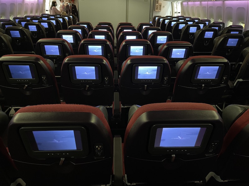 rows of seats with screens on the back