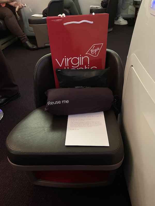 a seat with a bag and a paper on it