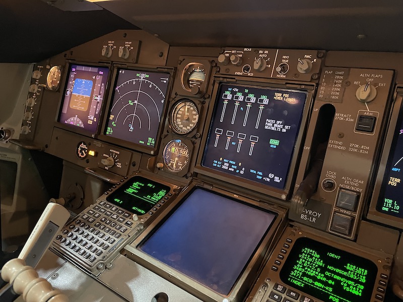 a cockpit of an airplane with many screens and buttons