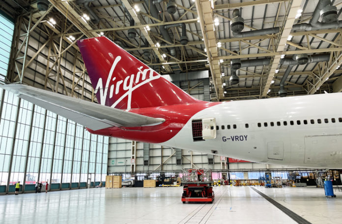 a red and white airplane in a hangar