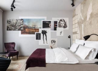 a bedroom with a bed and pictures on the wall