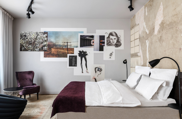 a bedroom with a bed and pictures on the wall