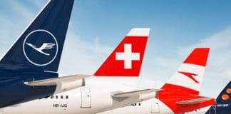 a group of airplanes parked on a runway
