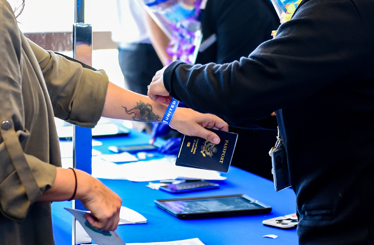 a person handing a passport to another person
