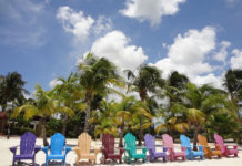 a group of colorful chairs on a beach
