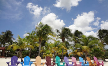 a group of colorful chairs on a beach