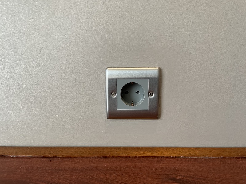a silver electrical outlet on a wall