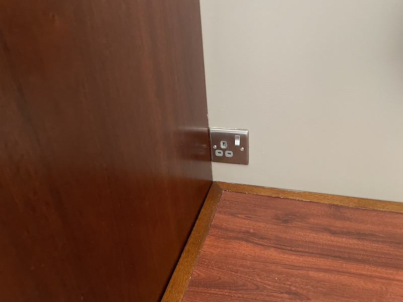 a wall outlet in a corner