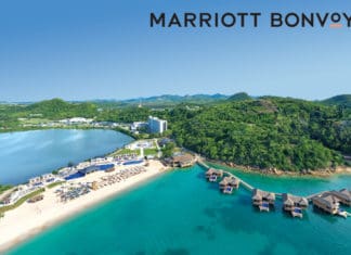 a beach with huts and a body of water