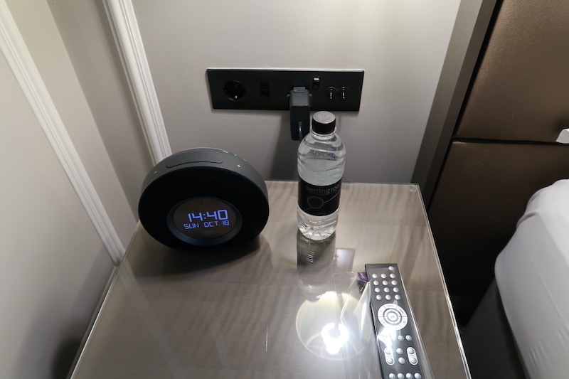a water bottle and alarm clock on a table