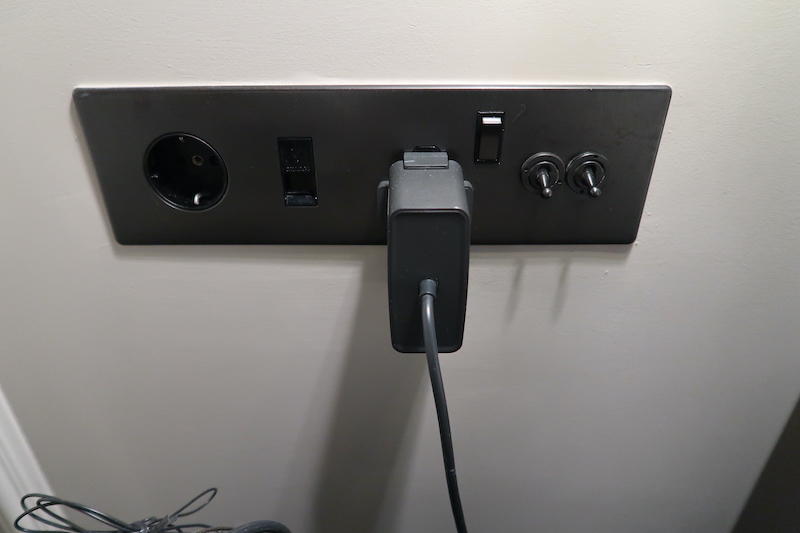 a black electrical outlet with a cord plugged into it