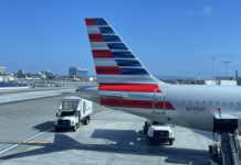 a tail of an airplane with a red white and blue stripe on it