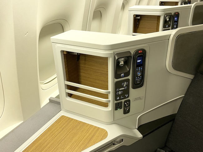 a white and wooden cabinet on an airplane