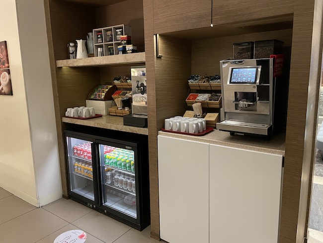 a coffee machine and refrigerator in a room