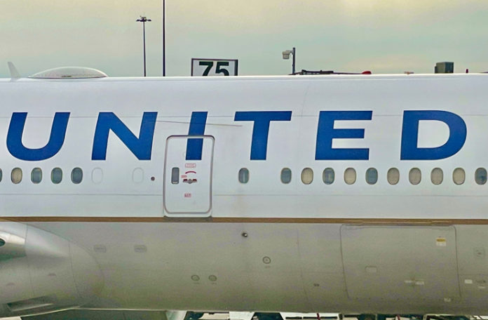 the side of a plane with blue writing on it