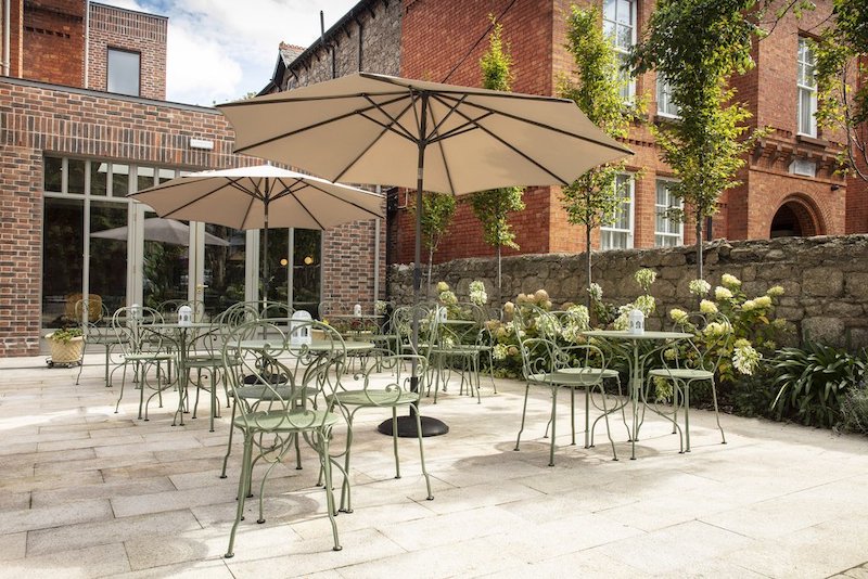 a patio with chairs and umbrellas