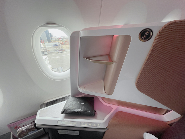 Tiny shelves to one side of the Virgin Atlantic Upper Class seat