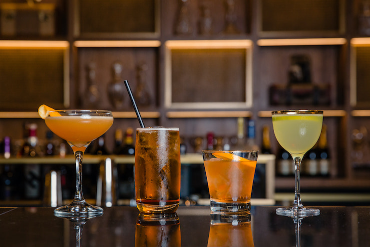 a group of drinks on a bar