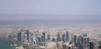 a city with many tall buildings and a body of water
