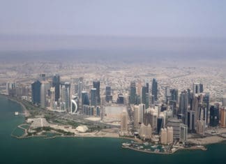 a city with many tall buildings and a body of water