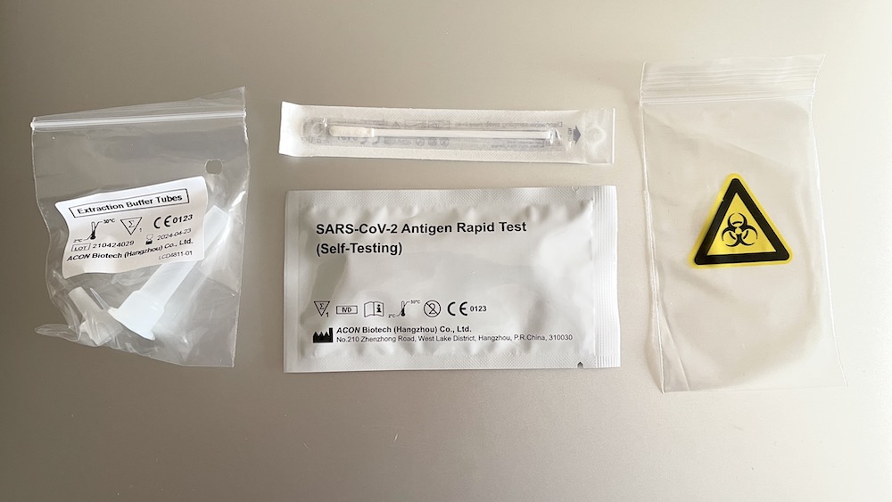 a group of plastic bags with a test tube and a test strip