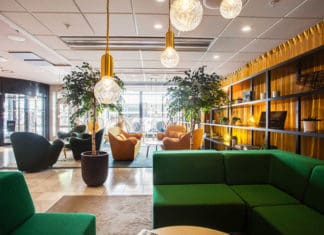 a room with green couches and chairs