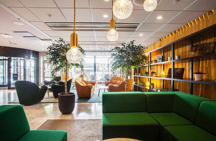 a room with green couches and chairs