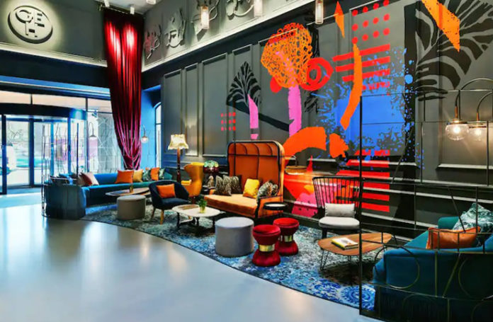 a room with a large wall with colorful furniture