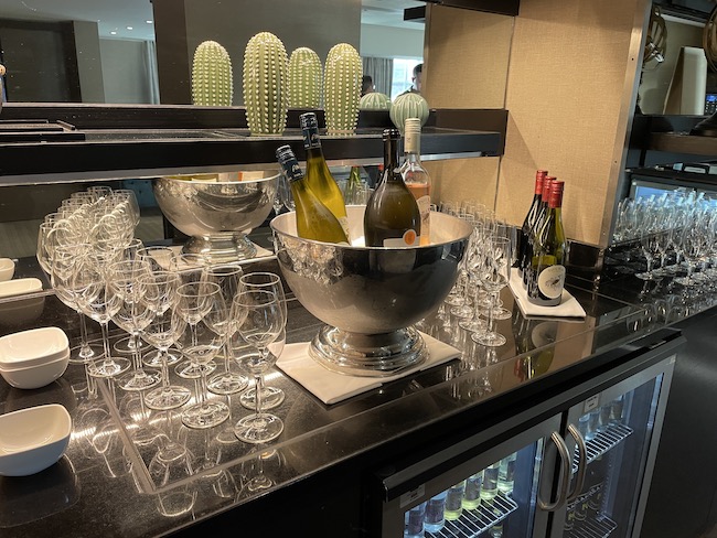a group of wine glasses and bottles on a counter