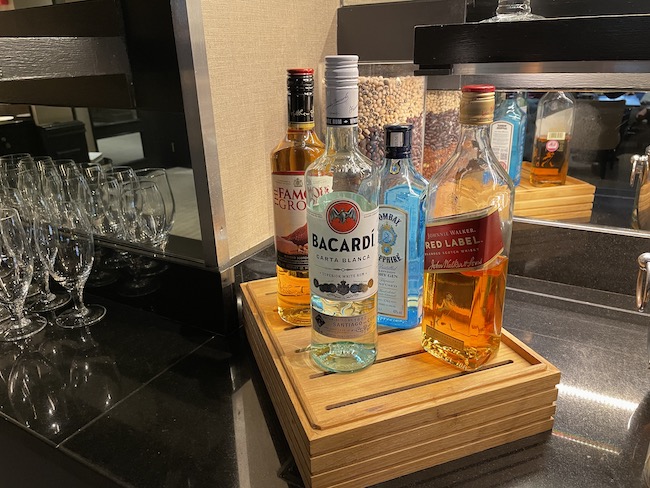 a group of bottles of alcohol on a wood tray