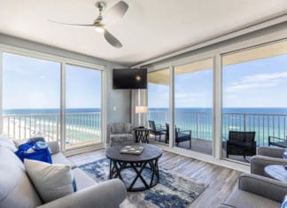 a living room with a view of the ocean