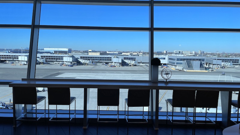 a window with chairs and a view of the airport
