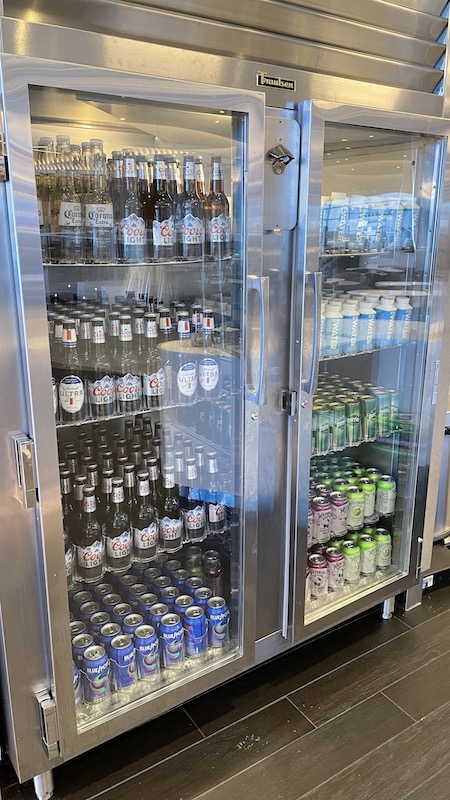 a refrigerator with bottles and cans