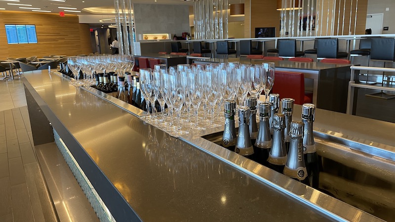a row of wine glasses and bottles on a bar