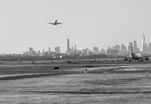 a plane flying over a runway