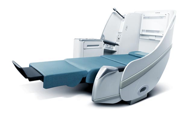 a medical bed with a seat and a drawer