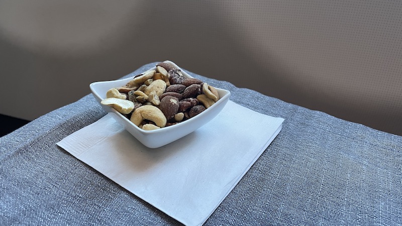 a bowl of nuts on a napkin